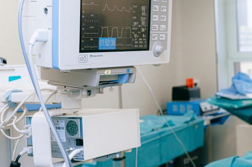 Close-up of vital signs monitor in a modern operating room setup.